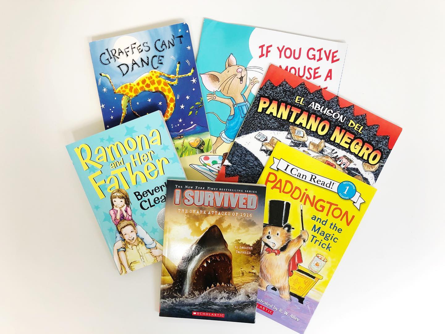 children's books lay on a white table