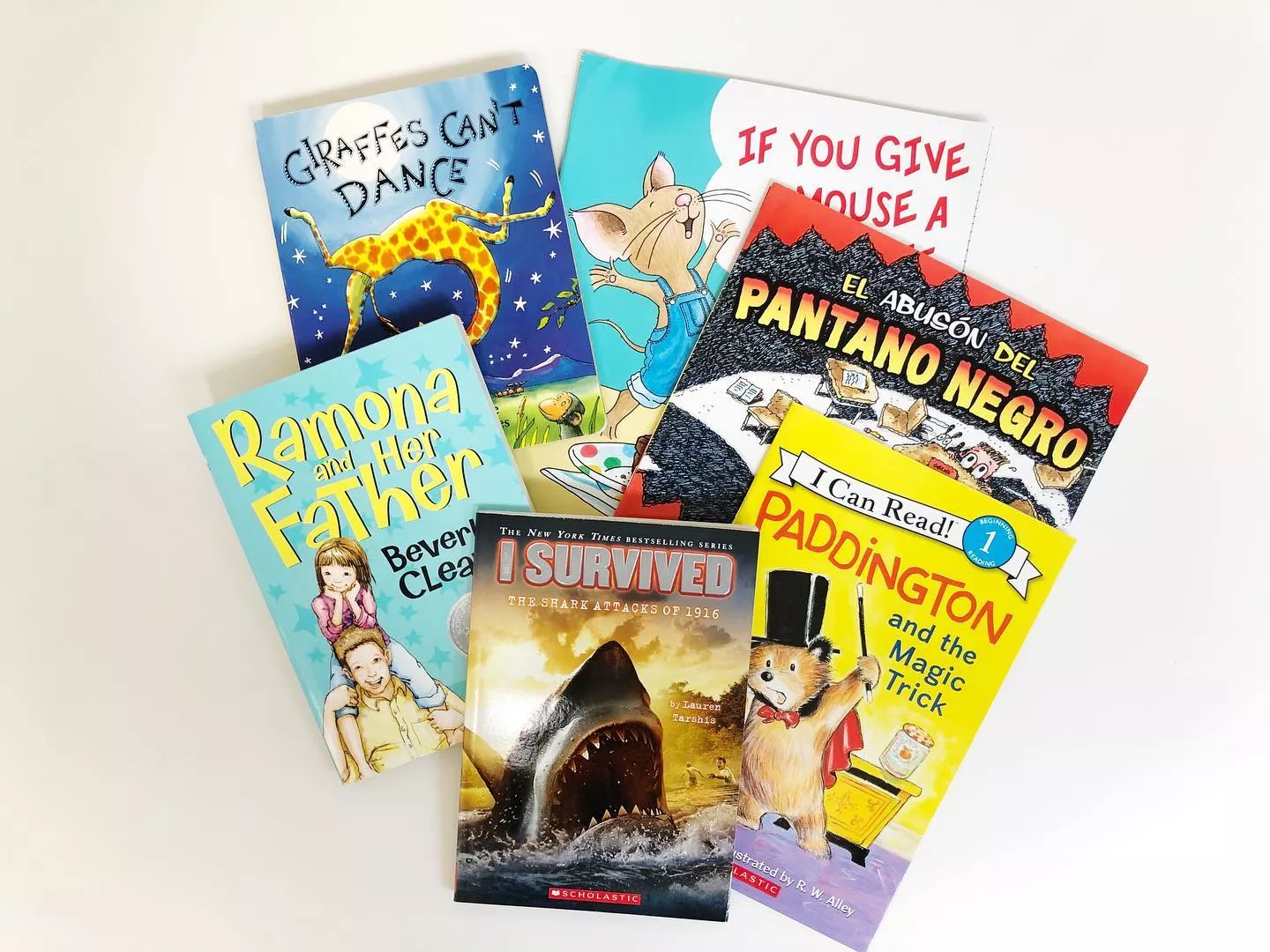 children's books lay on a white table